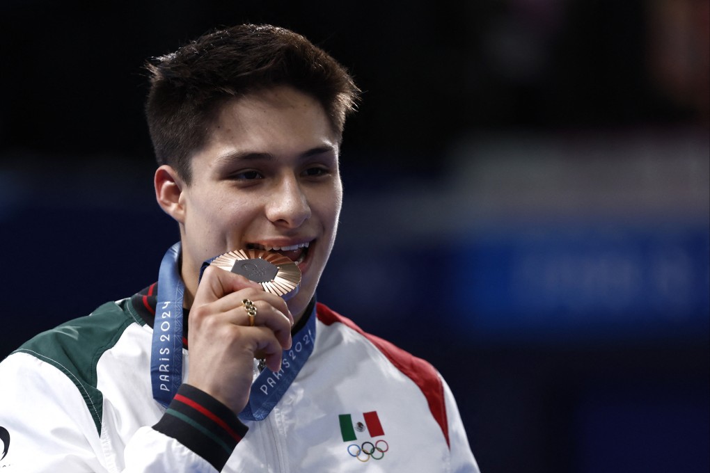 Osmar Olvera celebrates winning bronze in the men’s 3m springboard. Photo: Reuters