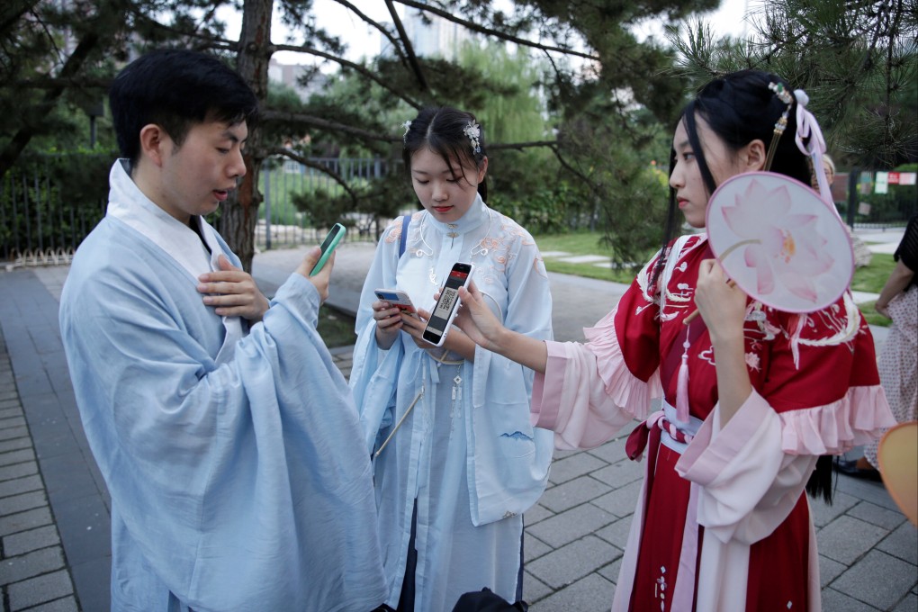 Young people dressed in traditional Hanfu clothing use their mobile devices at an event marking the Qixi Festival, the Chinese equivalent of Valentine’s Day, in Beijing on August 7, 2019. We look at the festival’s history, story, traditions, food and more. Photo: Reuters