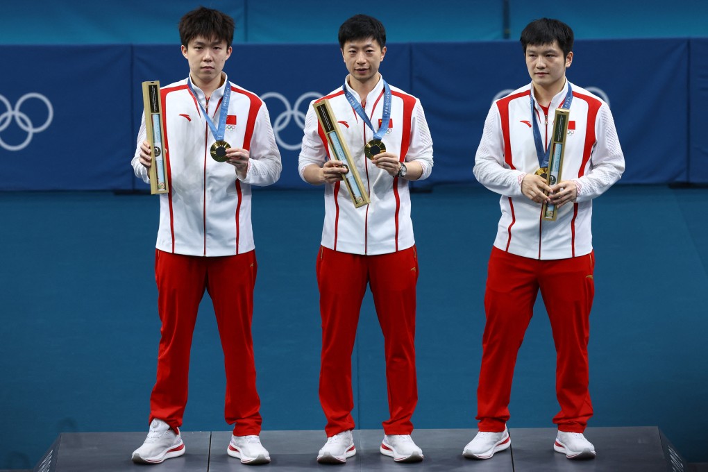 Ma Long (centre) with Wang Chuqin (left) and Fan Zhendong after winning the men’s team table tennis gold, Ma’s sixth at the Olympics. Photo: Reuters