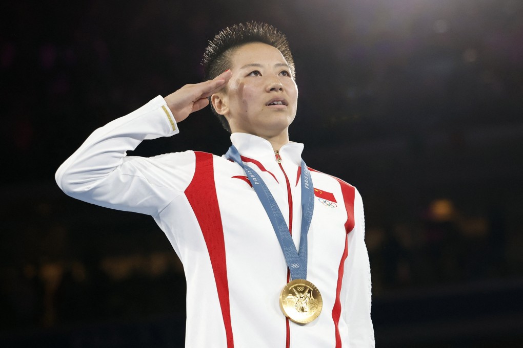 China gold medallist Wu Yu salutes her nation’s flag during the medal ceremony. Photo: Reuters