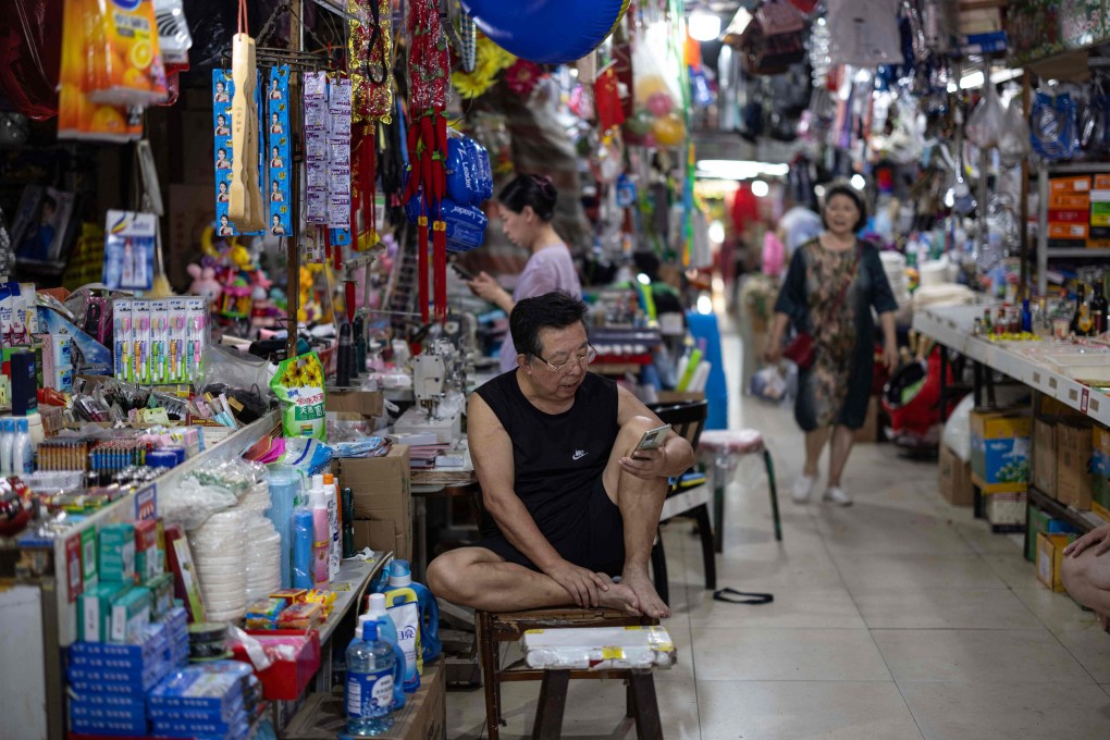 A vendor waits for customers at a market in Shenyang, in northeastern China’s Liaoning province. Photo: AFP