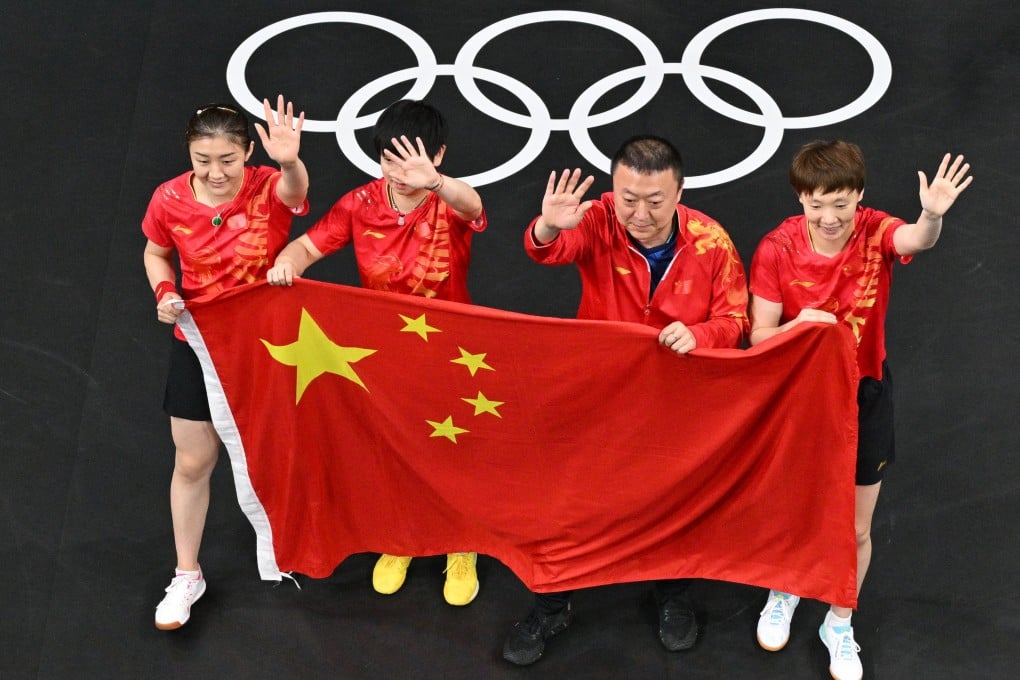 The China team and their coach wave to supporters after winning the women’s team table tennis gold. Photo: Reuters