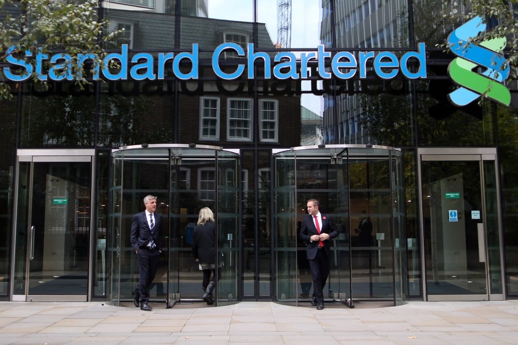 Visitors leave the headquarters of Standard Chartered in London. Photo: Bloomberg