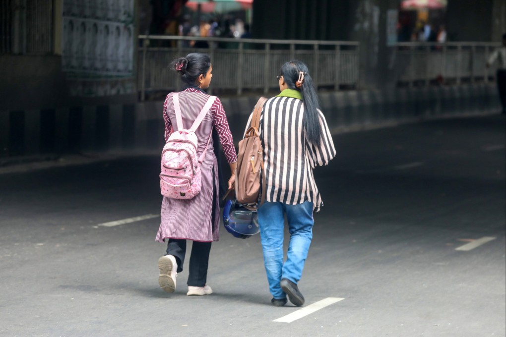 Bangladeshi women walk along the street in Dhaka after a curfew was relaxed following student-led protests. Photo: EPA-EFE