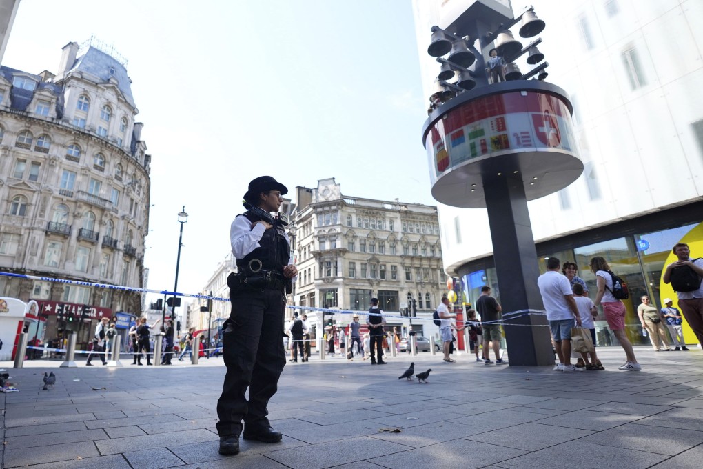A police officer stands at the scene in Leicester Square. Photo: AP