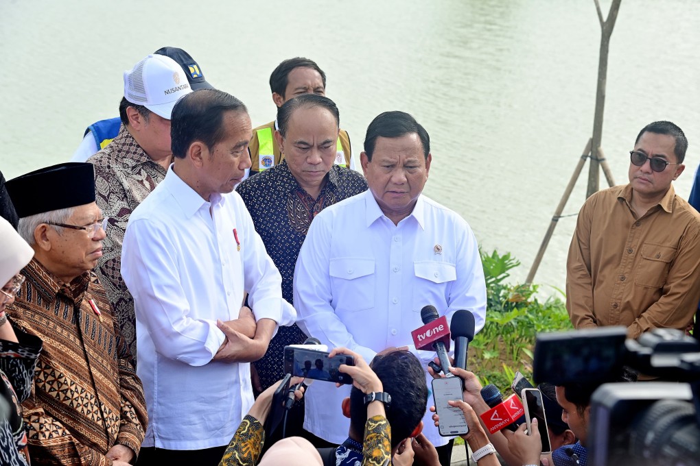 Indonesian President Joko Widodo (middle with crossed arms), accompanied by his Vice-President Maruf Amin (left) and president-elect and Defence Minister Prabowo Subianto (2-R), talks to journalists before their first cabinet meeting in Nusantara. Photo: EPA-EFE