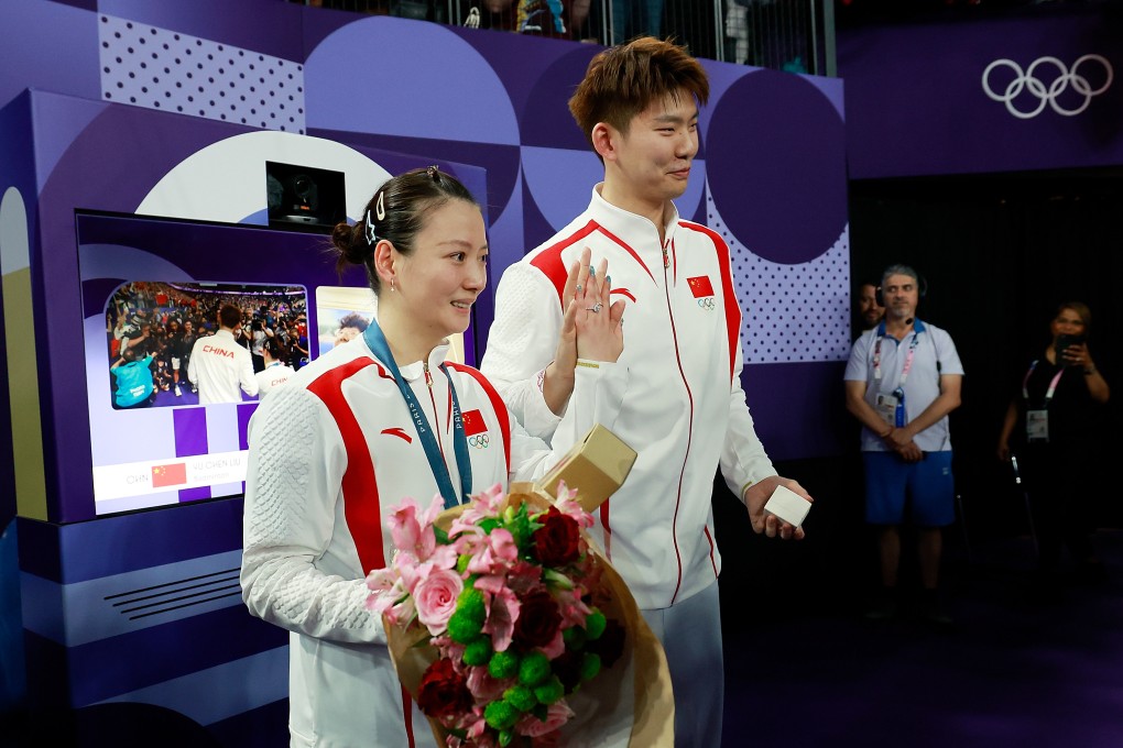 Liu Yuchen (right) and fiancee, gold medallist Huang Yaqiong, are all smiles after getting engaged in Paris. Photo: Xinhua