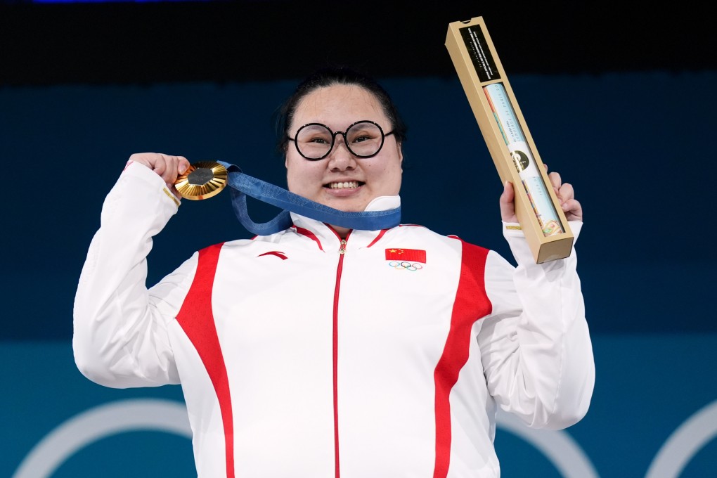 China’s Li Wenwen celebrates gold in the women’s +81kg weightlifting on the final day of the Games. Photo: dpa