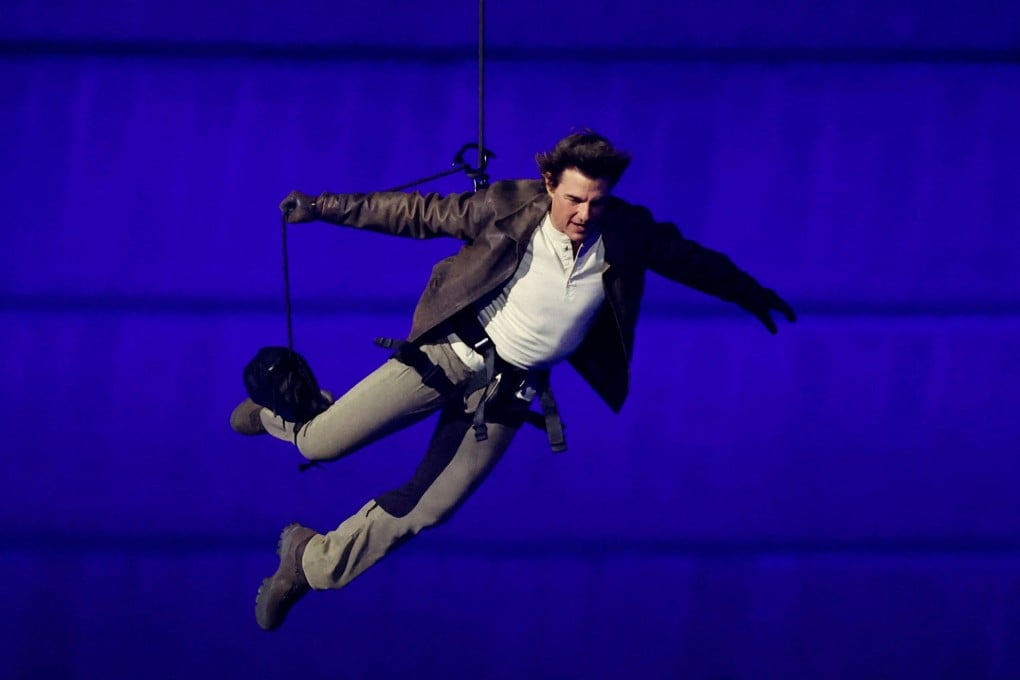 Actor Tom Cruise jumps from the roof of the Stade de France during the closing ceremony. Photo: Reuters