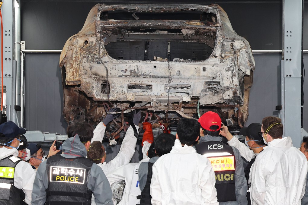 Officials inspect a Mercedes-Benz electric car that caught fire in Incheon, South Korea. Photo: Yonhap via Reuters