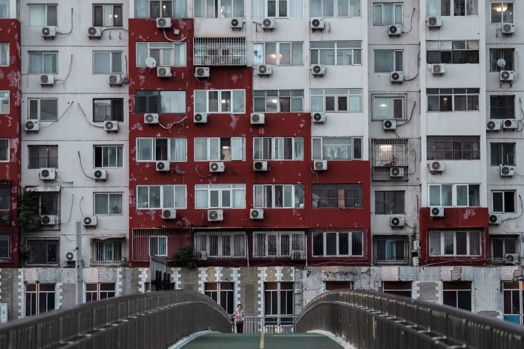 Air conditioning units on a building in Beijing on August 1. There is a natural bottom to the economic slowdown from the property downturn but investing in the state grid to prioritise renewable energy will secure a green and prosperous future. Photo: Bloomberg