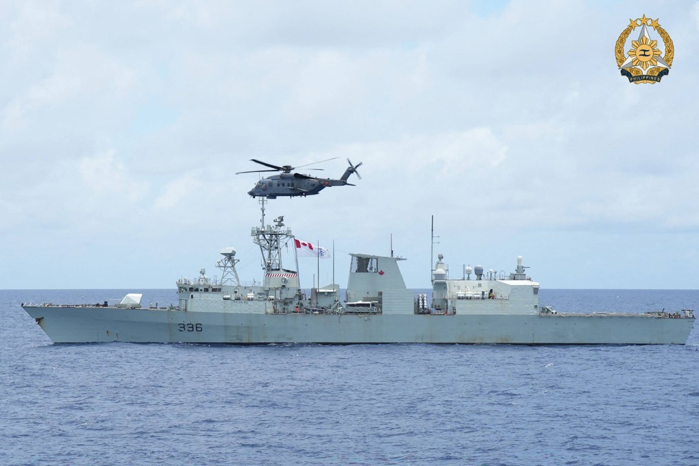 A helicopter hovers above a frigate during the joint Philippines, US, Canada, and Australia maritime drills in the South China Sea on August 7. Photo: AFP