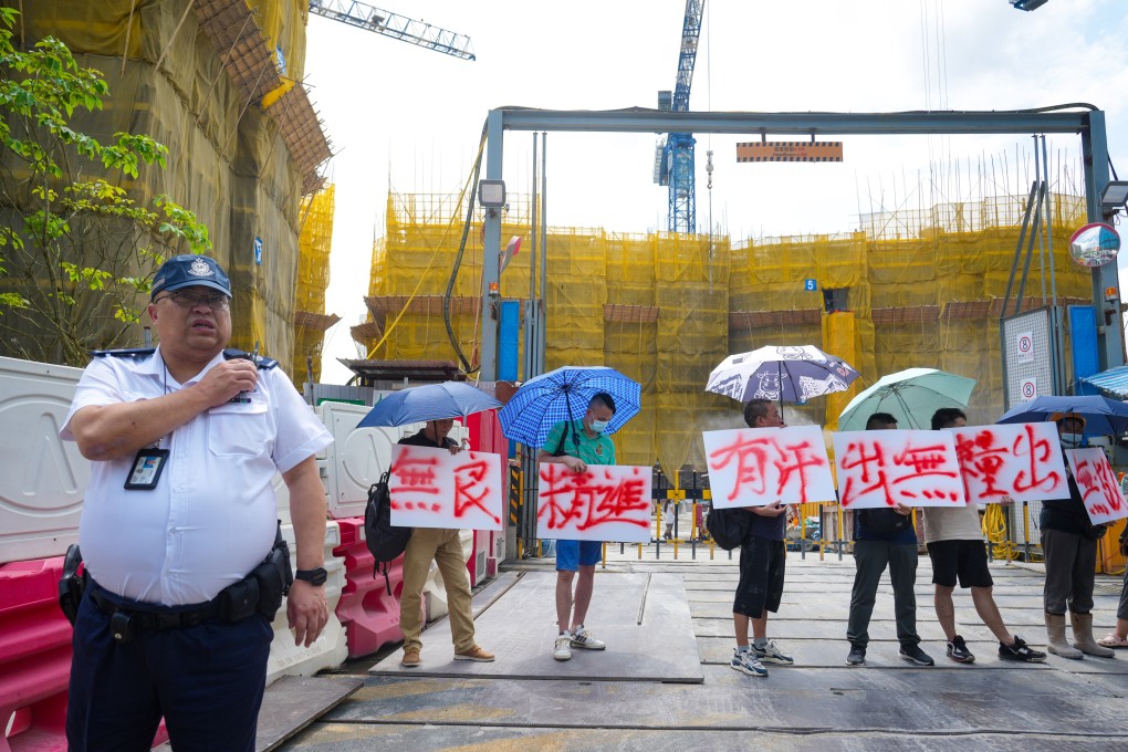 Protesting workers block the entrance to the construction site over unpaid wages. Photo: Sam Tsang