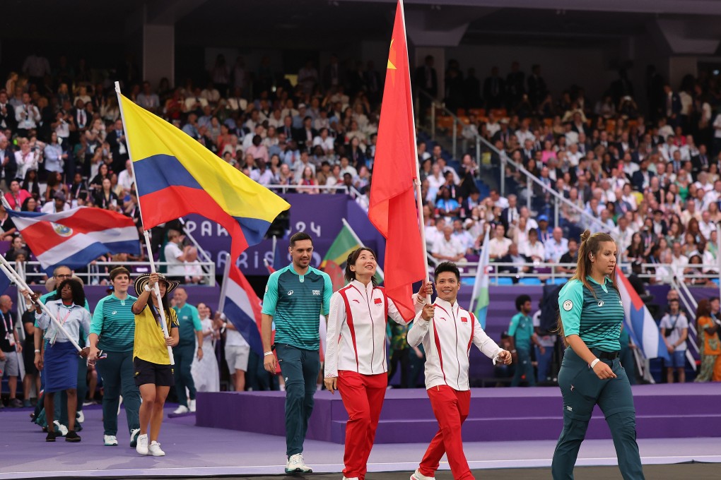 China’s flag-bearers Li Fabin (second from right) and Ou Zixia (third from right) arrive for the closing ceremony of the Paris 2024 Olympic Games alongside representatives of other countries at the Stade de France in Paris on  Sunday. Photo: Xinhua
