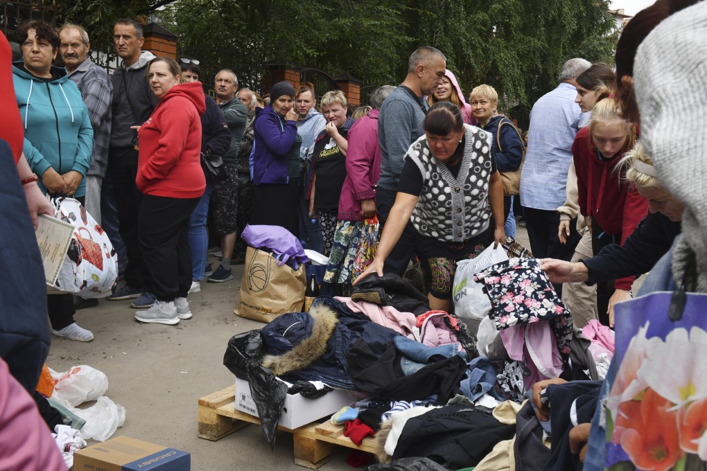 People evacuated from fighting between Russian and Ukrainian forces queue to receive humanitarian aid at a distribution centre in Kursk, Russia on Monday. Photo: AP