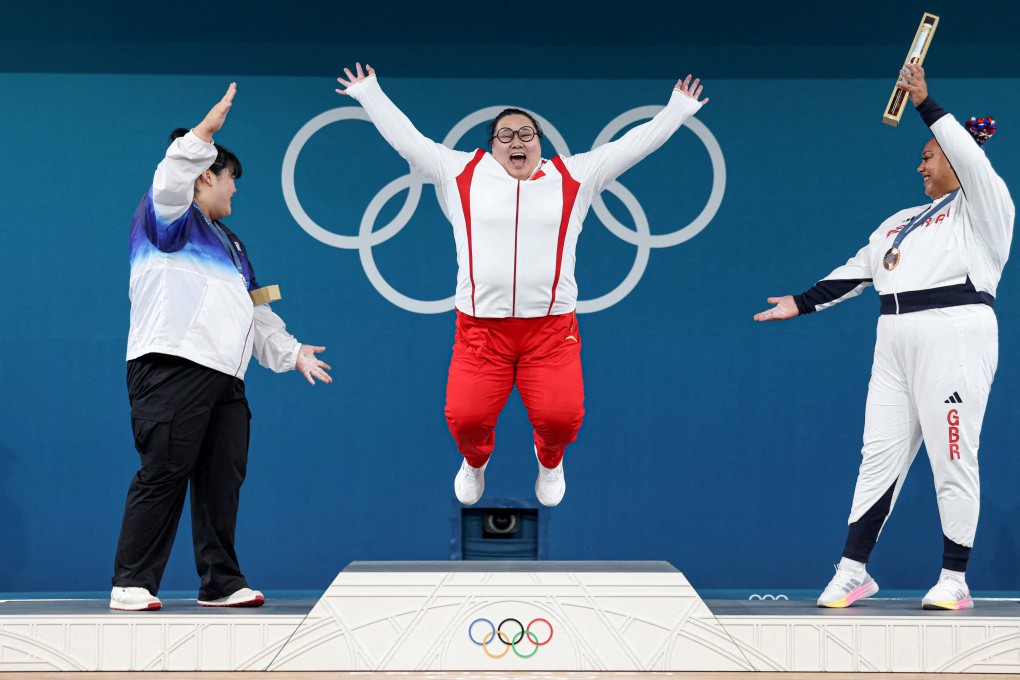 Women’s +81kg weightlifting gold medallist Wenwen Li (centre) of China celebrates on the podium with silver medallist Park Hye-jeong (left) of South Korea and bronze medallist Emily Campbell of Britain at the South Paris Arena in Paris on August 11. Photo: Reuters