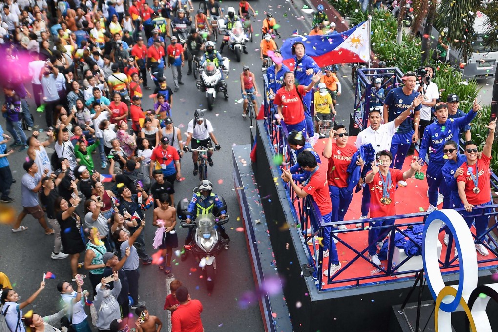 Carlos Yulo (centre, front on float) and other Filipino athletes who competed in Paris, taking part in a homecoming parade along the streets of Manila on Wednesday. Photo: AFP