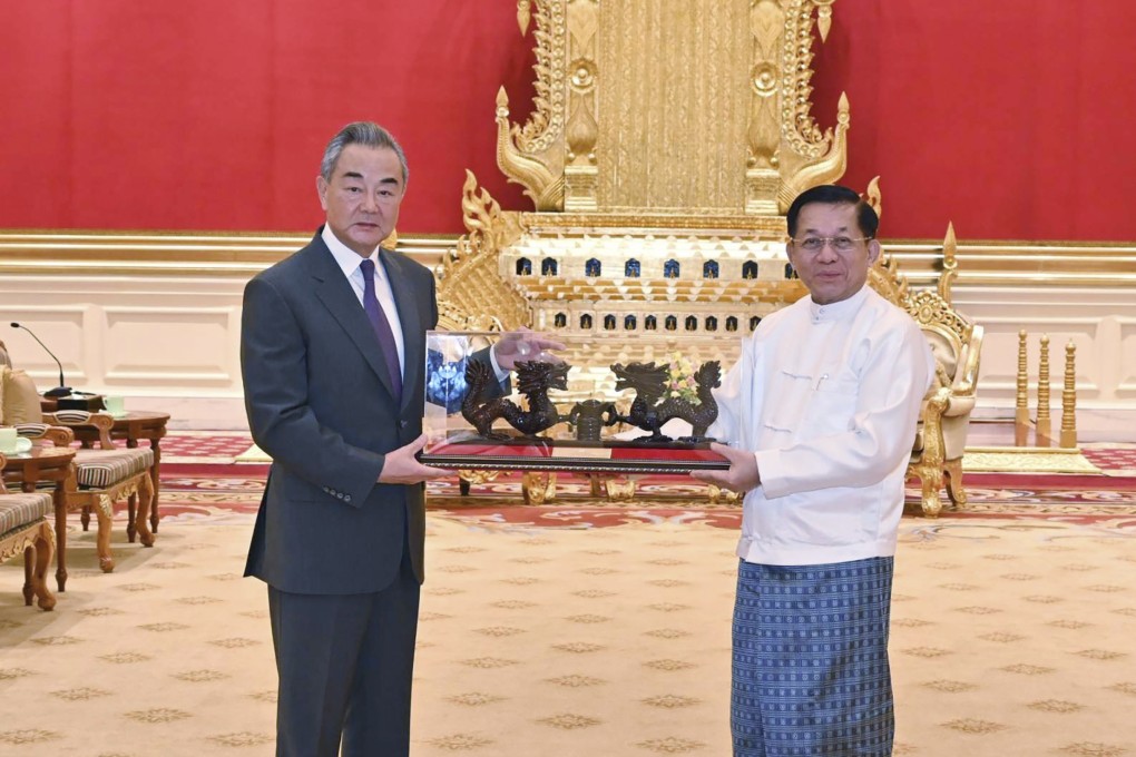 Myanmar’s military leader Senior General Min Aung Hlaing (right), chairman of the State Administration Council, exchanges gifts with Chinese Foreign Minister Wang Yi during their meeting on Wednesday in Naypyidaw. Photo: Myanmar Military True News Information Team via AP