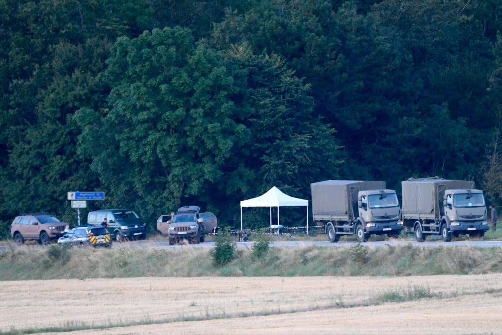 French gendarmes and French military vehicles stand beside the forest in Autreville, eastern France, on Wednesday after a crash between two French military Rafale jets. Photo: AFP