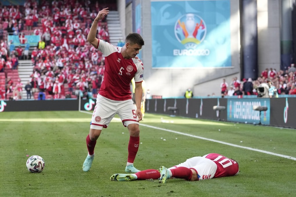 Denmark’s Joakim Maehle reacts as his teammate Christian Eriksen lies on the pitch after suffering a sudden cardiac arrest during the Euro 2020 soccer match between Denmark and Finland on June 12, 2021. We look at the causes of sudden cardiac arrest, how to prevent it in young athletes, and how to save the life of someone suffering one. Photo: AP