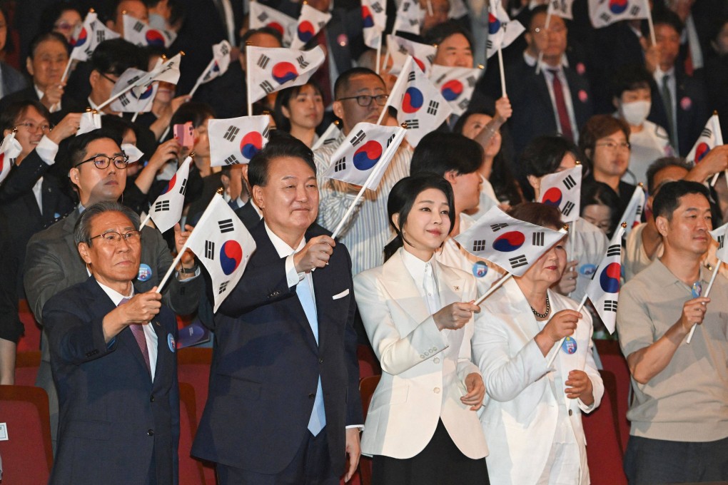 South Korea’s President Yoon Suk-yeol (centre left) waves the national flag during a ceremony to mark the 79th Korean National Liberation Day in Seoul on Thursday. Photo: AFP