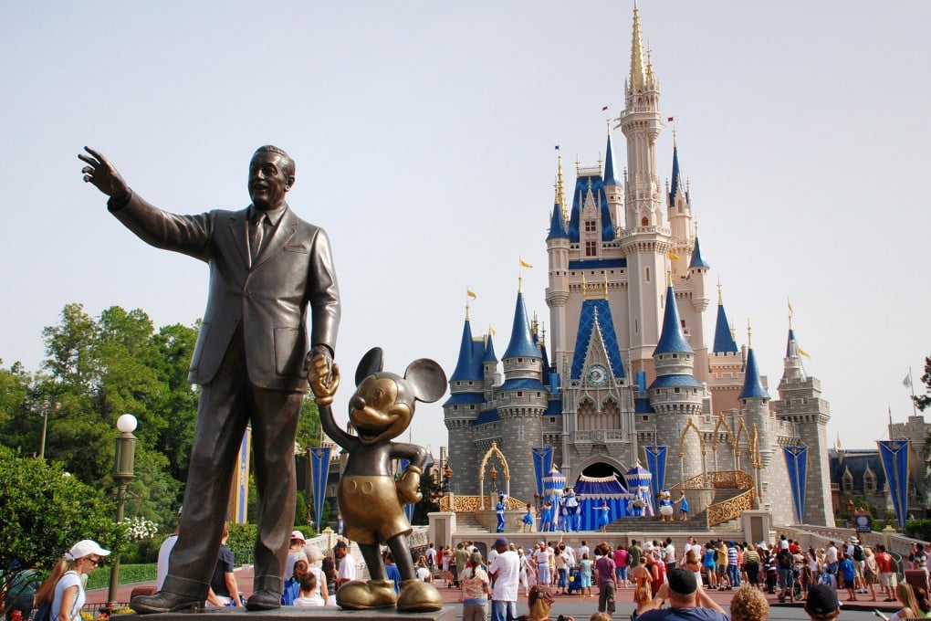 A statue of Walt Disney with Mickey Mouse is seen outside the entrance to Cinderella’s Castle at Disney World in Orlando, Florida. Photo: TNS