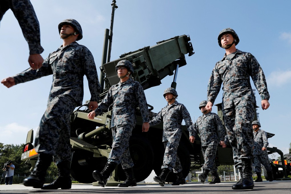 Japanese soldiers walk past a US Patriot missile battery during a troop review in Tokyo. Photo: Reuters