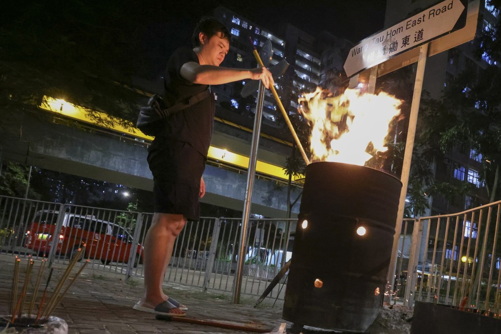 A worshipper burns paper offerings during the Hungry Ghost Festival in Lok Fu, Hong Kong. Photo: May Tse