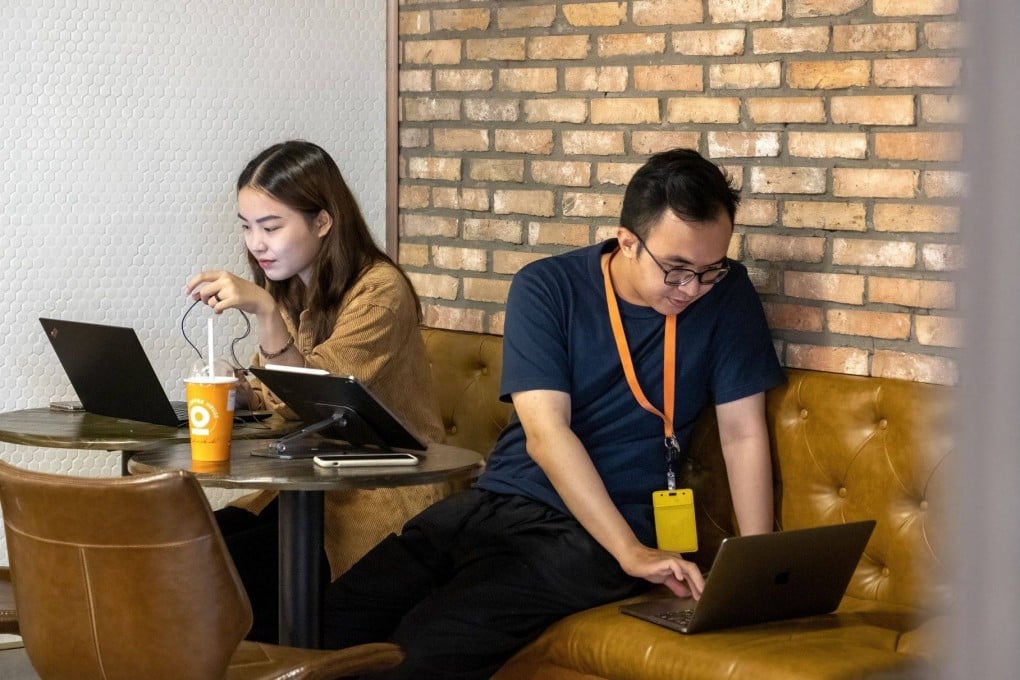People use their laptops in an internet cafe in Ho Chi Minh City, Vietnam. Photo: Bloomberg