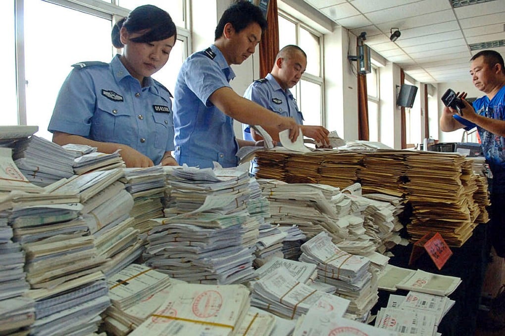 Chinese police inspect bundles of fake invoices seized in Beijing and Hebei province. Photo: Ministry of Public Security