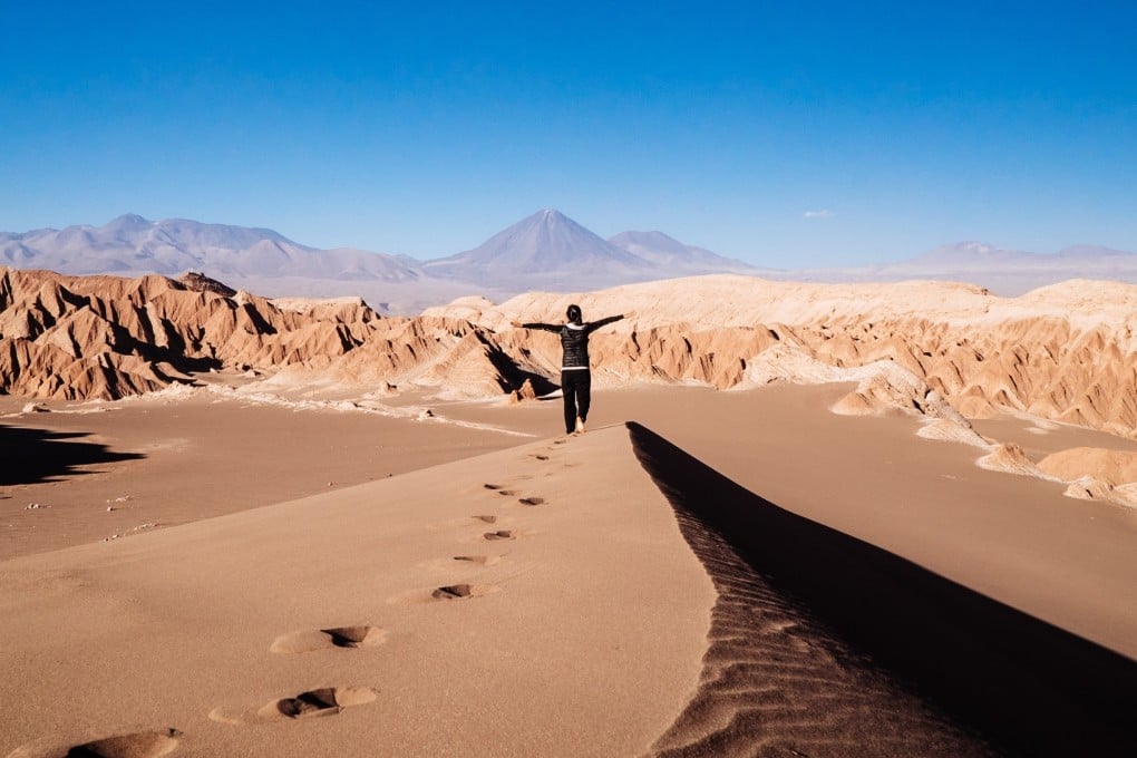 A traveller looks out over sand dunes in the Atacama Desert - the world’s driest - in Chile, which also offers some of the best stargazing spots. Photo: Shutterstock