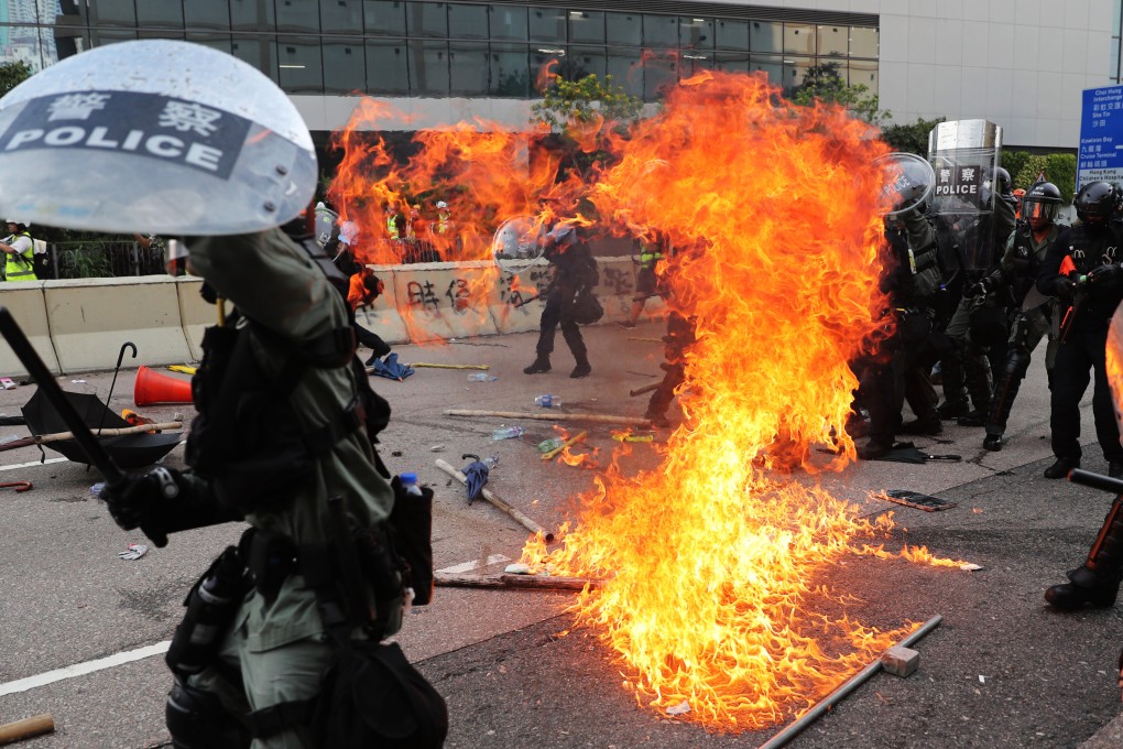 A petrol bomb lands near riot police in Ngau Tau Kok during protests in August 2019. Photo: Sam Tsang