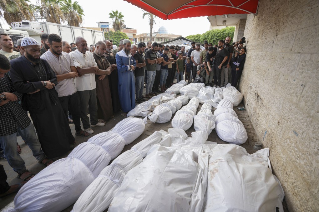 Palestinian mourners pray at a funeral for more than 15 people, including several children and women, killed in an Israeli strike, at Al-Aqsa Martyrs Hospital in Deir al-Balah, Gaza Strip, on Saturday. Photo: AP