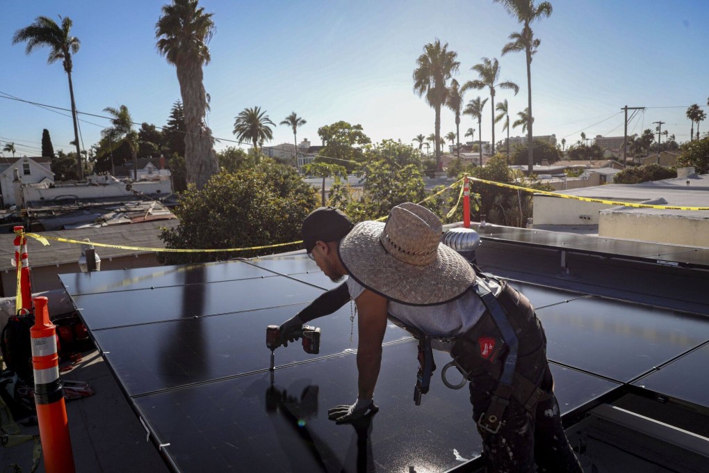 A worker installs solar panels on a residential rooftop in Poway, California, on December 5, 2023. Photo: Bloomberg