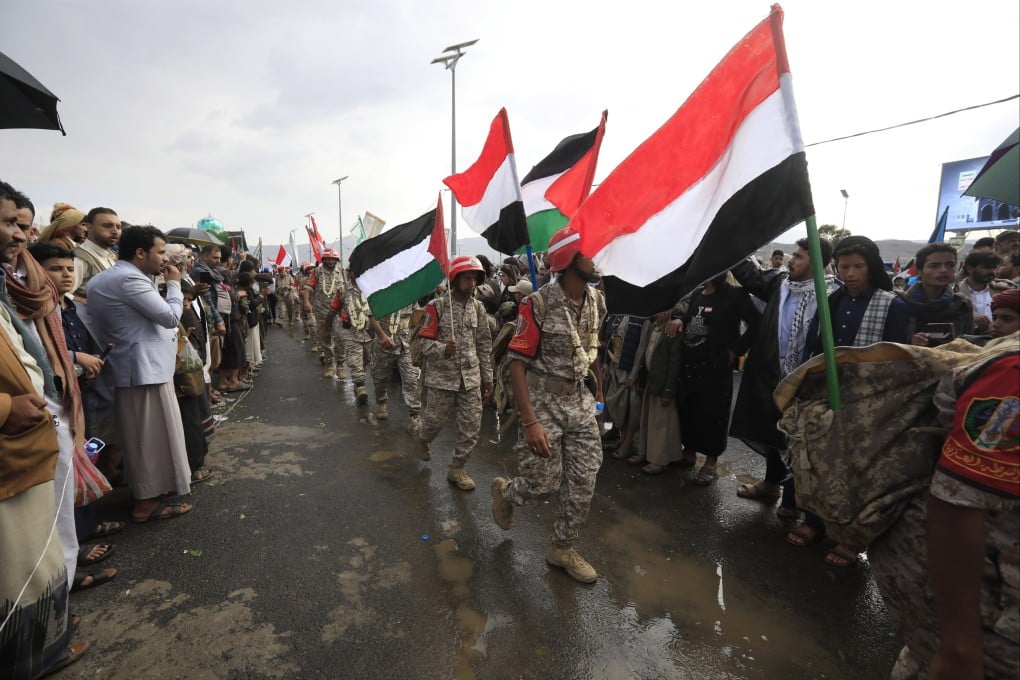 Houthi soldiers march during an anti-US and Israel protest, in Sana’a, Yemen, on Friday, carrying the flags of Yemen and Palestine. Photo: EPA-EFE