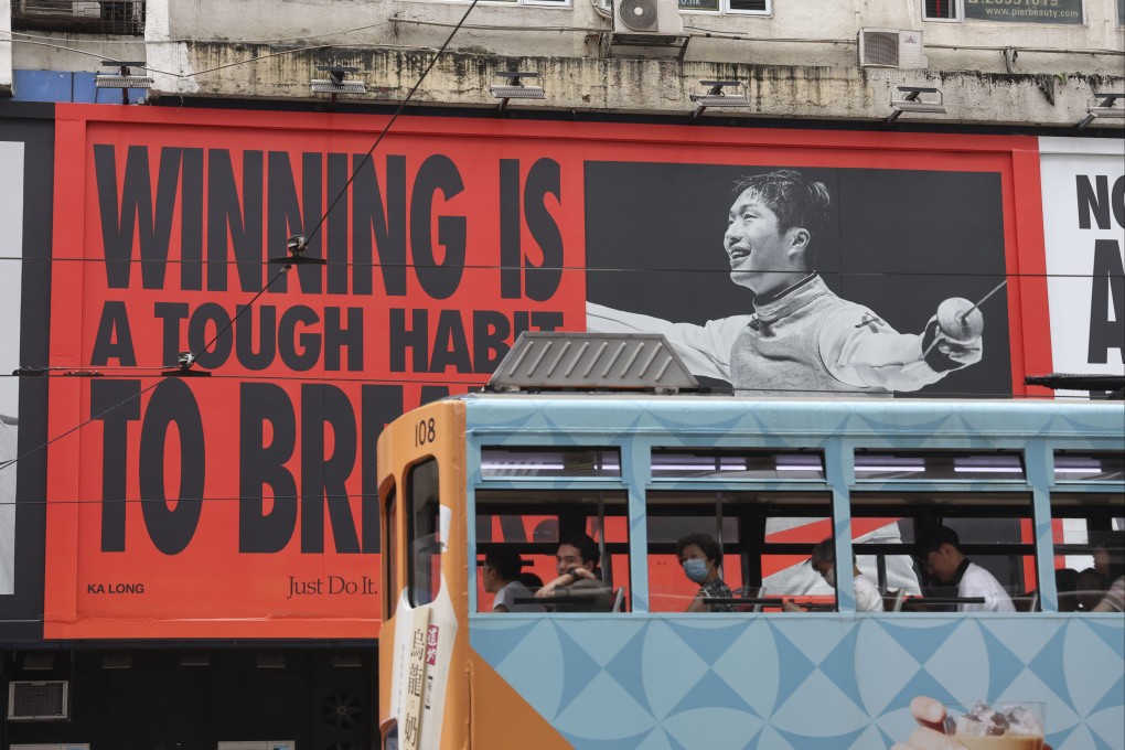 A tram passes an advertisement featuring Hong Kong fencer and Olympic gold medalist Cheung Ka-long in Causeway Bay on August 17. Photo: Dickson Lee