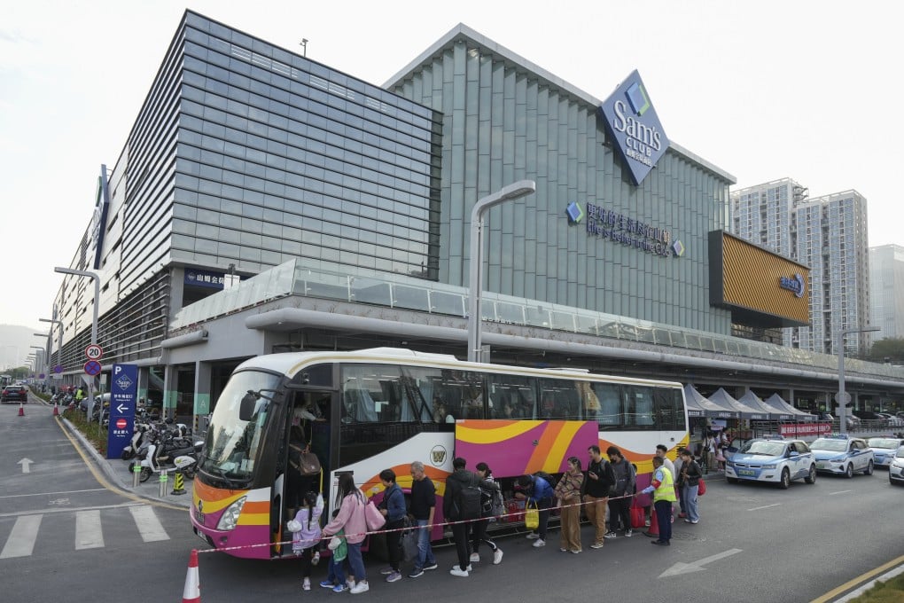 Shoppers from Hong Kong board a coach bus outside a Sam’s Club across the border in Shenzhen. Hongkongers have become more keen on heading north to shop in megastores. Photo: Eugene Lee