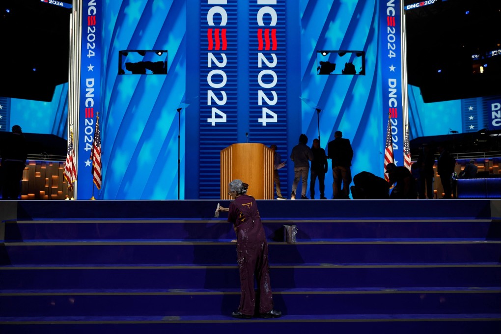 A worker paints the stage on Sunday amid preparations for the Democratic National Convention in Chicago, Illinois. Photo: Getty Images via AFP