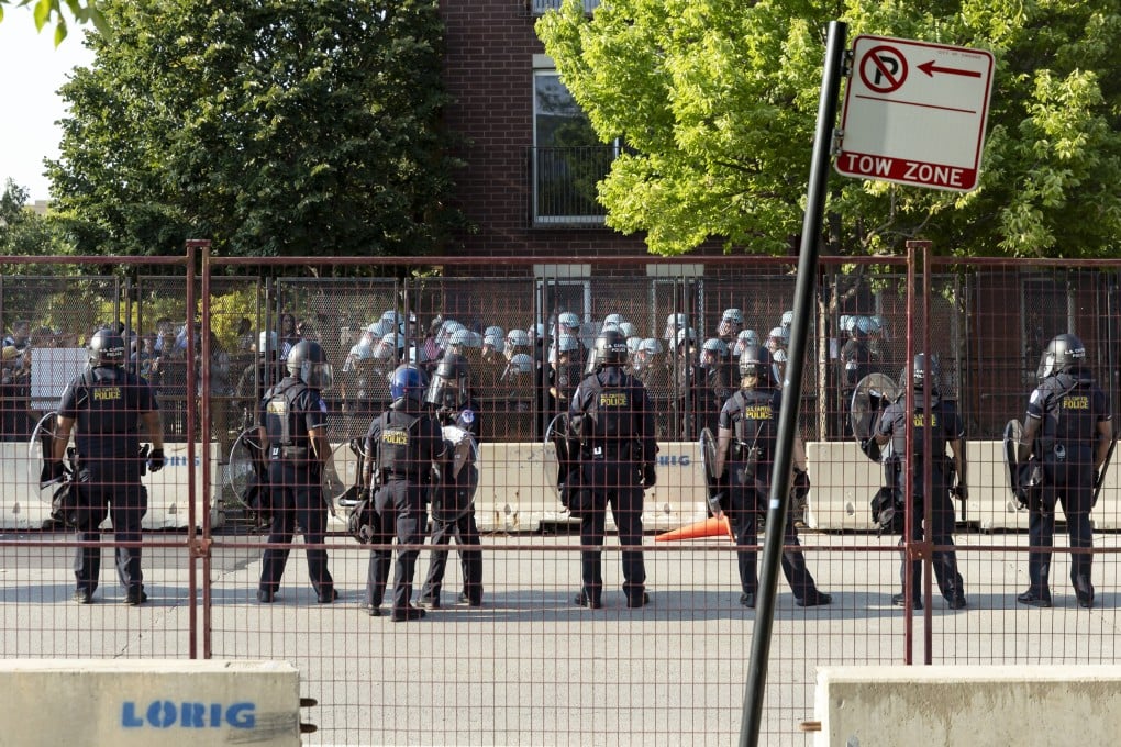 Police in riot gear confront protesters breaking through the perimeter fencing on the opening night of the Democratic National Convention (DNC) at the United Centre in Chicago, Illinois on Monday. Photo: EPA-EFE