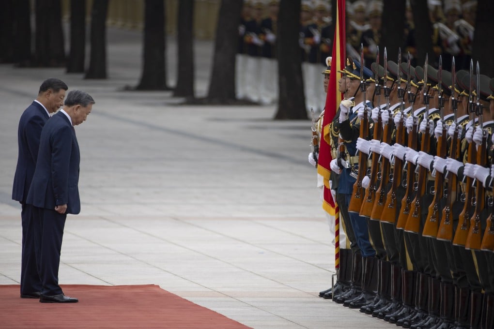 Xi Jinping and To Lam bow towards an honour guard in Beijing. Photo: EPA-EFE