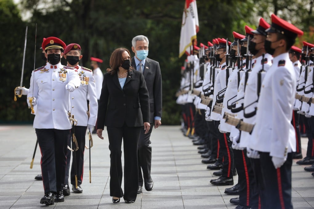 Singapore’s then-Prime Minister Lee Hsien Loong (centre right) and US Vice-President Kamala Harris (centre left) inspect a guard of honour during a welcome ceremony in August 2021. Photo: EPA-EFE