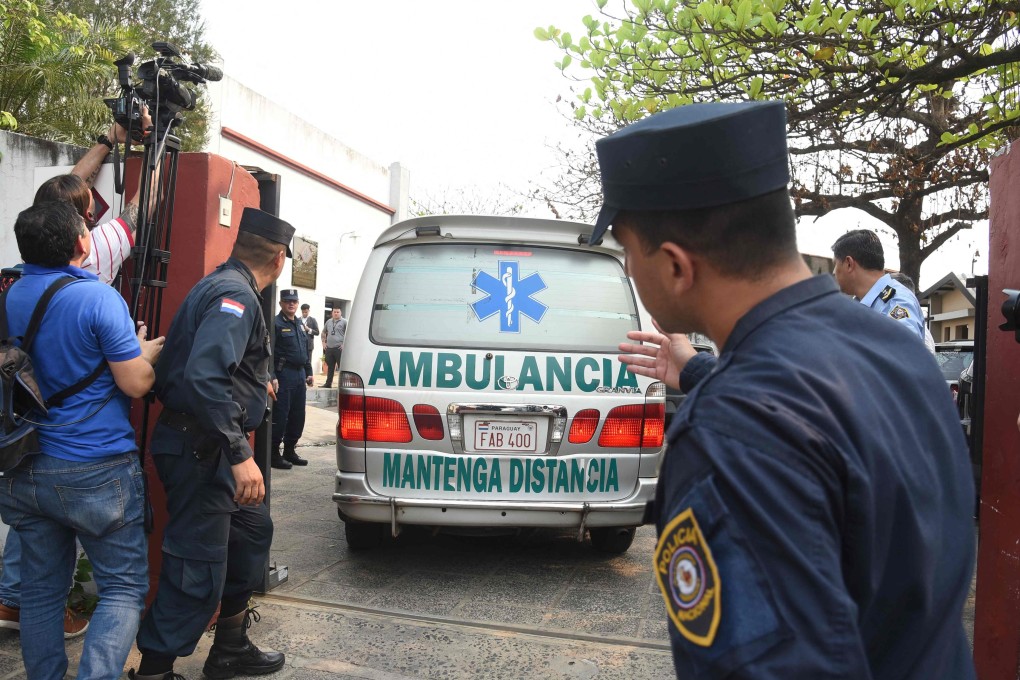 An ambulance carrying the body of Eulalio “Lalo” Gomez arrives at the local morgue in Asuncion on August 19. Photo: AFP