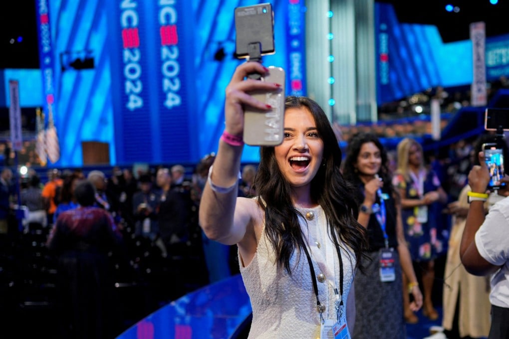 A social media influencer uses a phone during the Democratic National Convention. Photo: Reuters