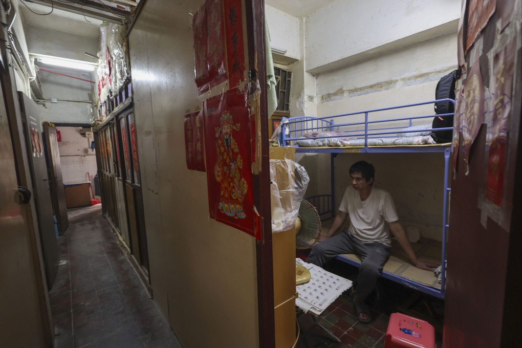 A resident in a Sham Shui Po subdivided flat with no windows or air conditioning. A government task force has submitted its assessment report of such substandard housing. Photo: Dickson Lee