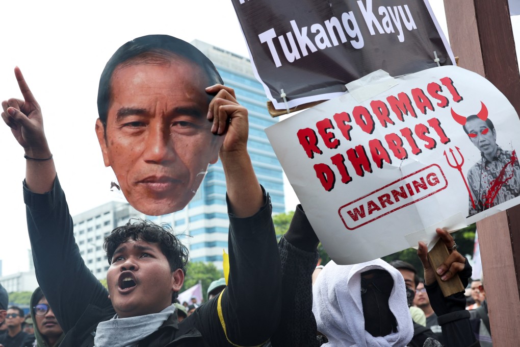 A demonstrator holds a cutout of Indonesian President Joko Widodo during a protest outside the Indonesian parliament on August 22 against the revisions to the country’s election law. Photo: Reuters