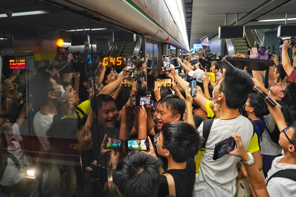Fans crowd the platform in a bid to get onto the themed train for its first trip. Photo: Elson Li