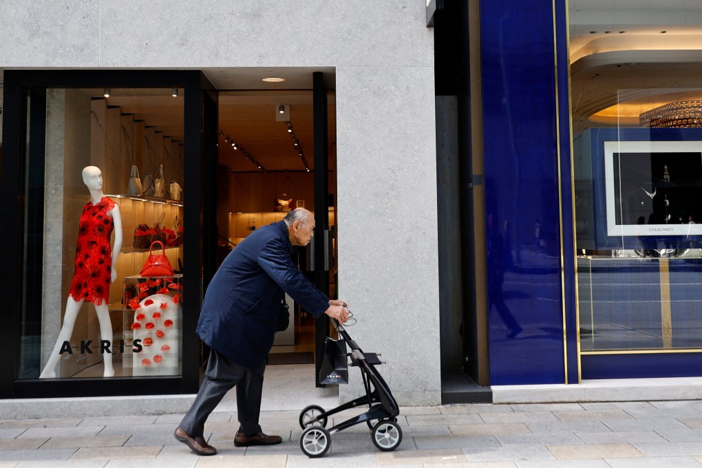 A man makes his way through a shopping district in Tokyo, on March 19. Japan is grappling with a rapidly declining population and escalating social security costs. Photo: Reuters