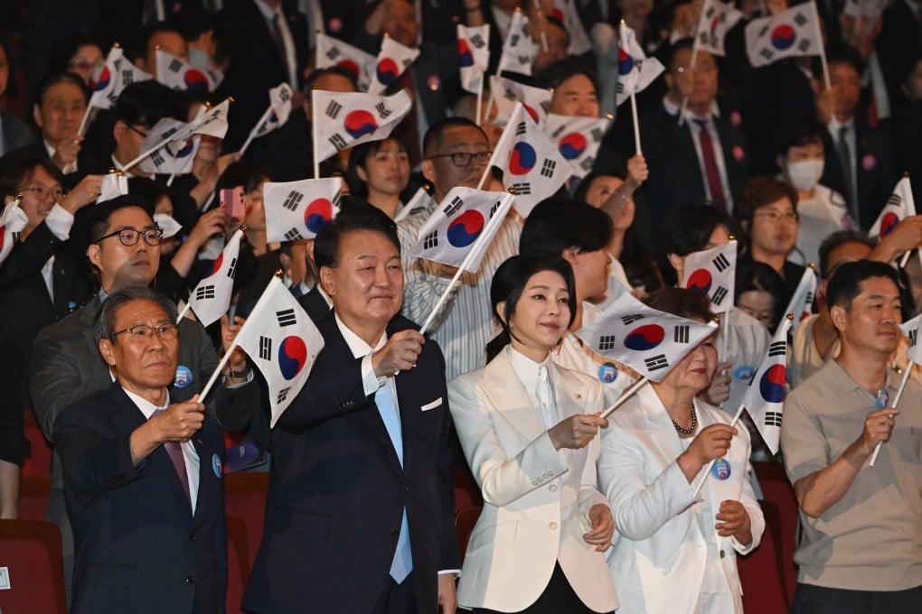 South Korean President Yoon Suk-yeol and his wife Kim Keon-hee wave national flags during the celebration of the 79th National Liberation Day in Seoul on August 15. Photo: EPA-EFE