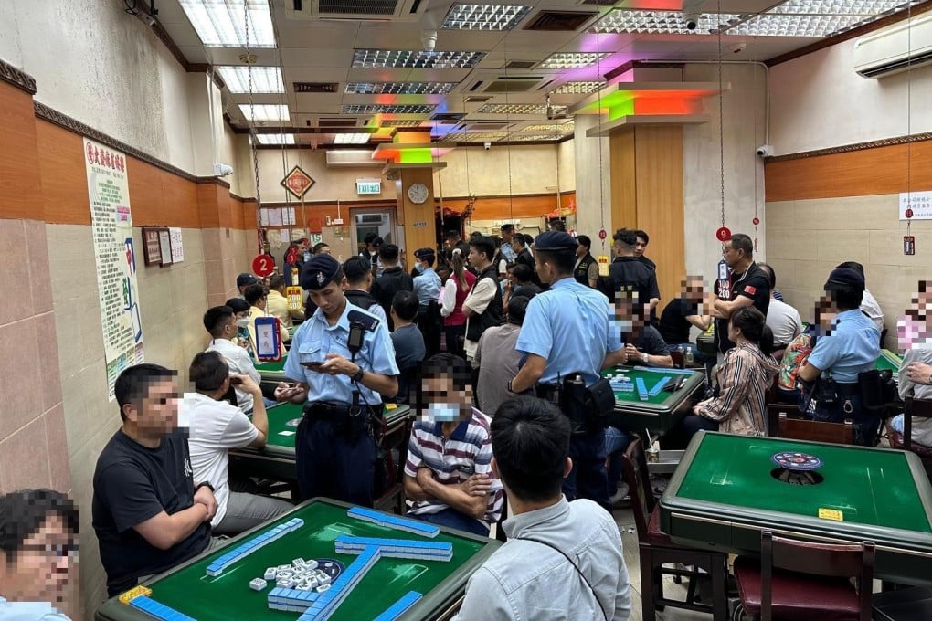 Officers check identification documents while carrying out the operation. Photo: Hong Kong police