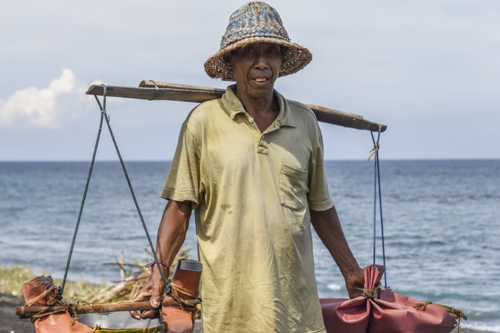 The salt farmers of Kusamba, Bali, bring salt water up the black-sand beach in palm-leaf buckets. Photo: Ronan O’Connell